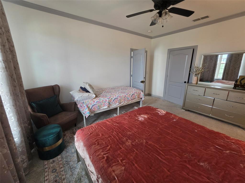 809 Rockingham Drive Irving, TX 75063 - Photo 12 of 30 Neutral wall paint, ceiling fan with integrated lighting, two panel interior doors, and crown molding