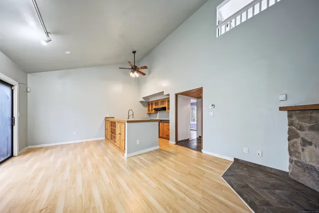 a view of a kitchen with wooden floor