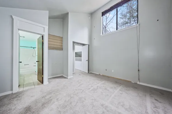 an empty room with windows and closet