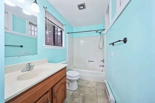 a bathroom with a sink a toilet a shower and a mirror