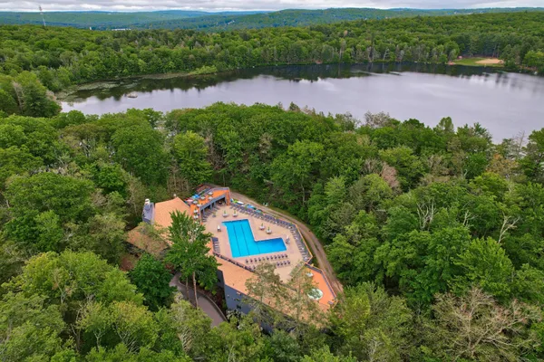 a dining room with furniture and a floor to ceiling window
