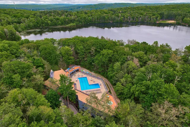 a dining room with furniture and a floor to ceiling window