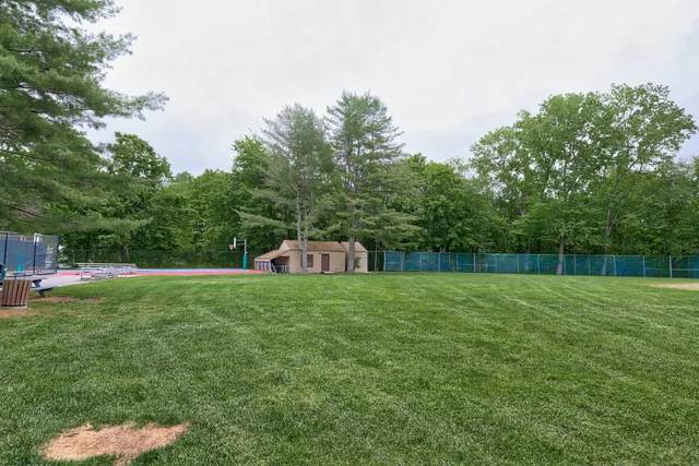 a pathway of a house with a yard