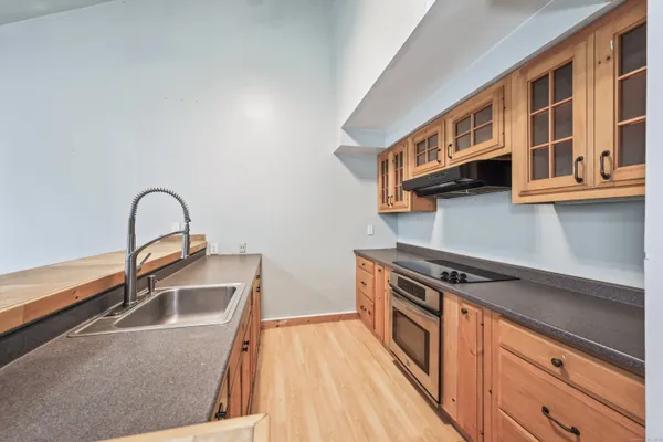 a kitchen with stainless steel appliances granite countertop a stove a sink and a microwave