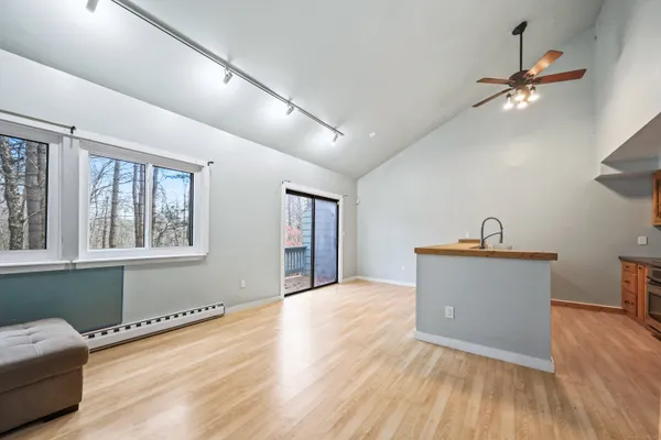 a view of a room with wooden floor and a window