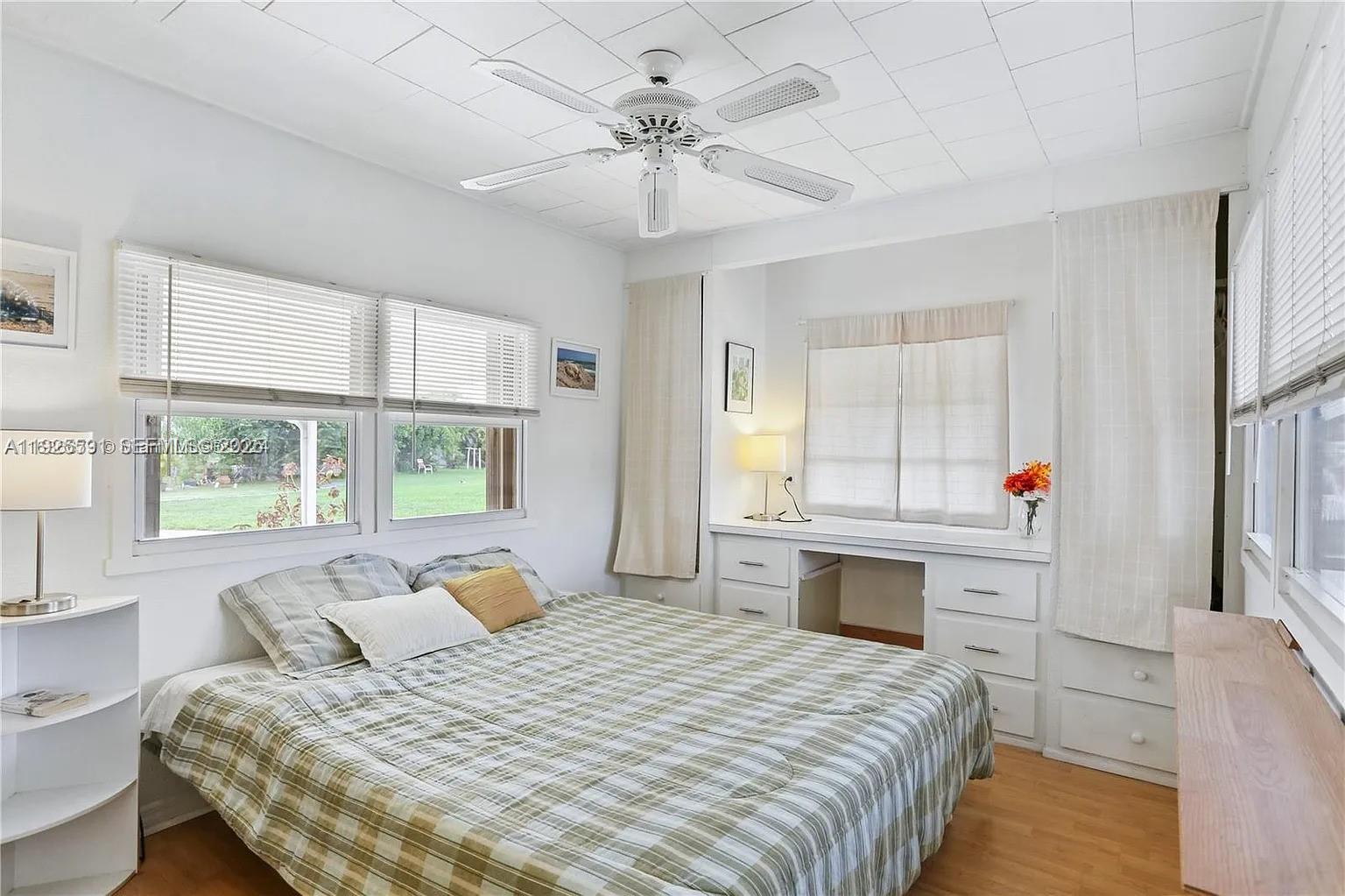 8616 Southwest 16th Place Davie, FL 33324 - Photo 12 of 21 a bedroom with a bed and a chandelier