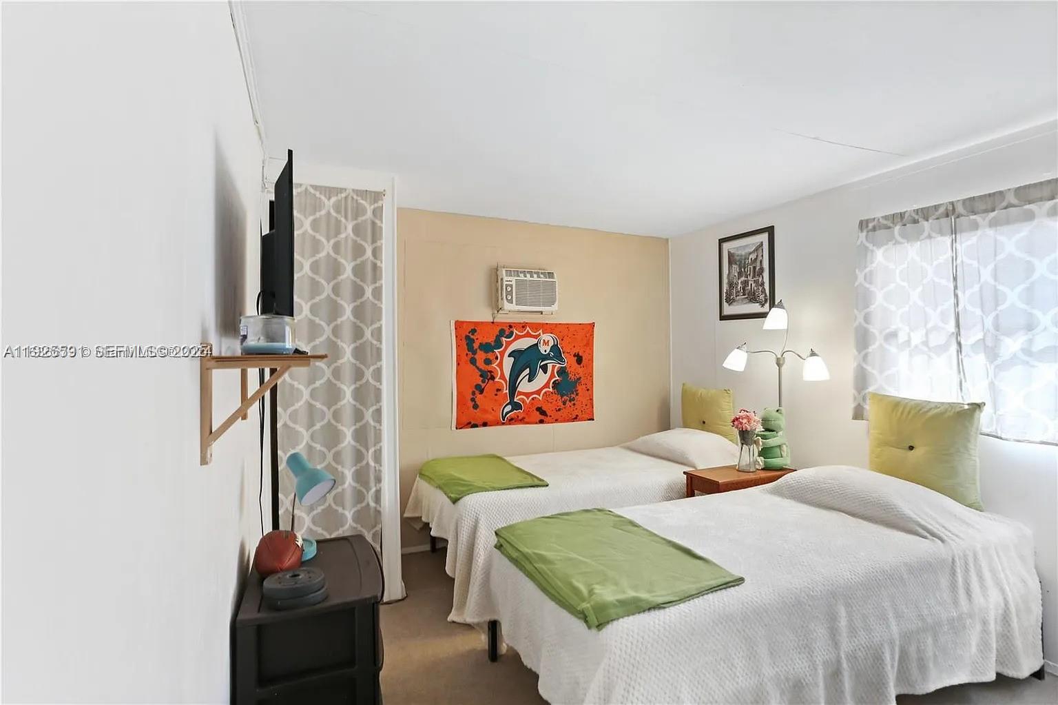 8616 Southwest 16th Place Davie, FL 33324 - Photo 14 of 21 a bedroom with a bed and a painting on the wall