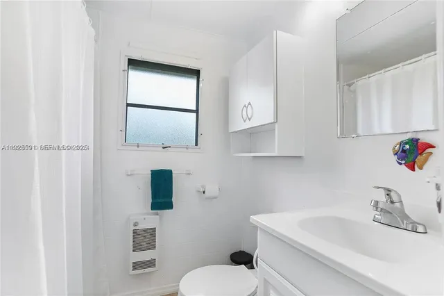 a bathroom with a sink toilet and mirror
