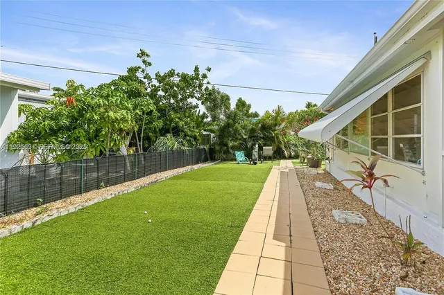 a view of a backyard with sitting area