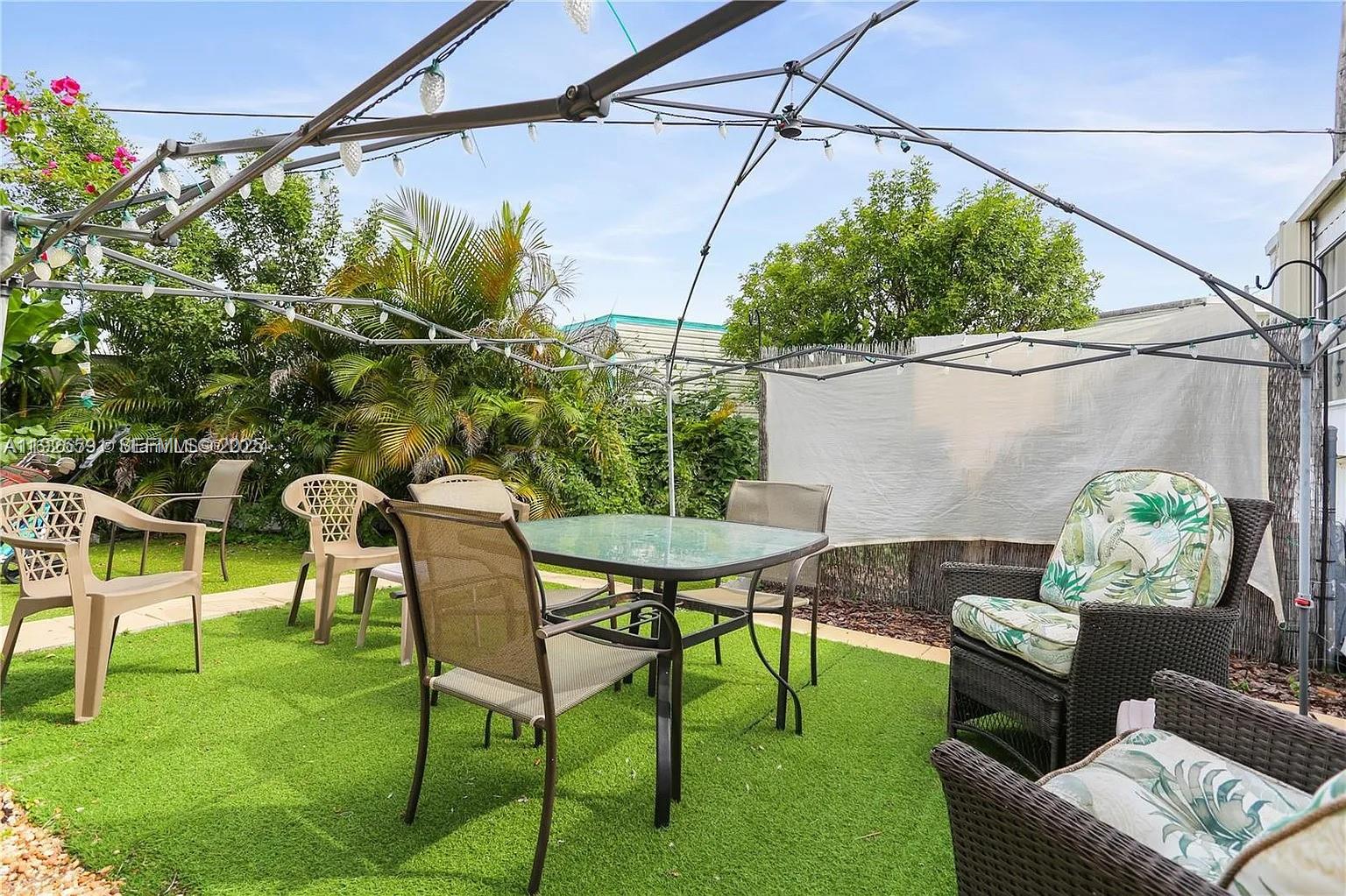 8616 Southwest 16th Place Davie, FL 33324 - Photo 19 of 21 a backyard of a house with table and chairs