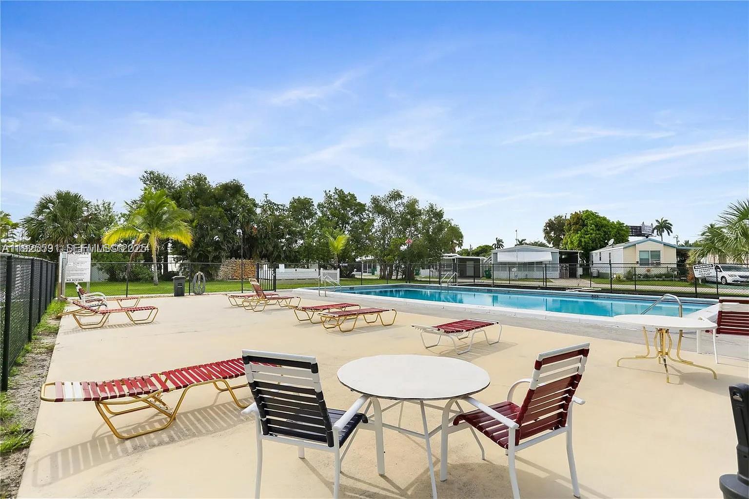 8616 Southwest 16th Place Davie, FL 33324 - Photo 20 of 21 a view of a swimming pool with lounge chairs
