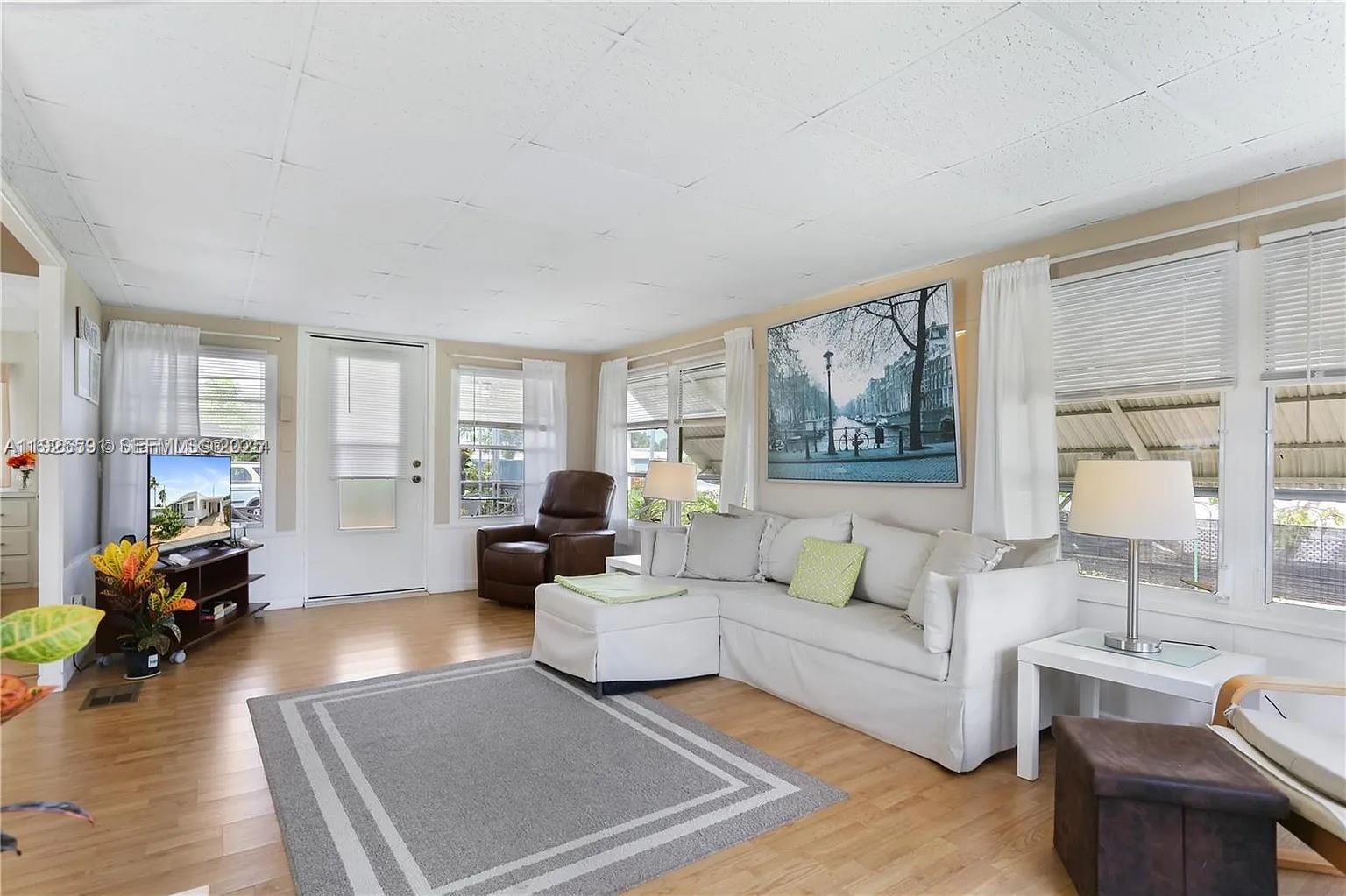 8616 Southwest 16th Place Davie, FL 33324 - Photo 5 of 21 a living room with furniture large window and wooden floor