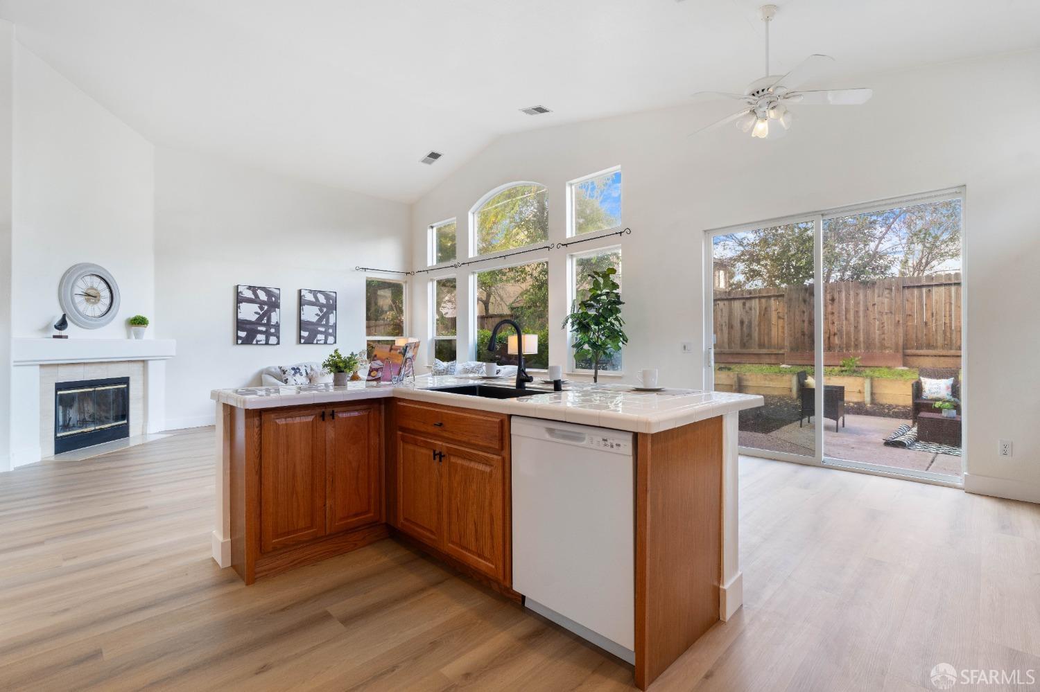 2626 Orange Way Antioch, CA 94531 - Photo 5 of 56 a large white kitchen with wooden floors and a fireplace