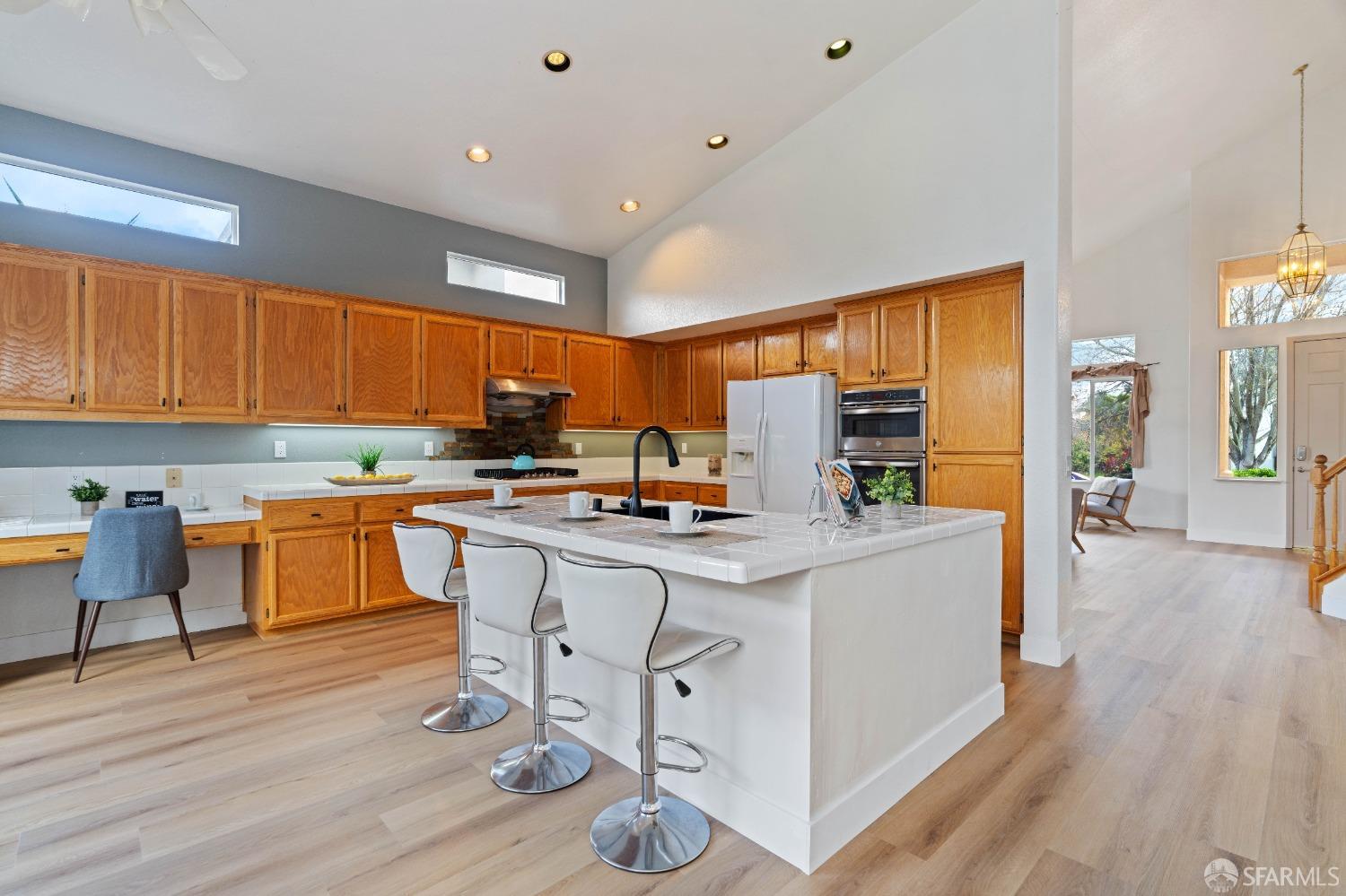 2626 Orange Way Antioch, CA 94531 - Photo 7 of 56 a kitchen with stainless steel appliances granite countertop a refrigerator a stove top oven a sink dishwasher and white cabinets with wooden floor