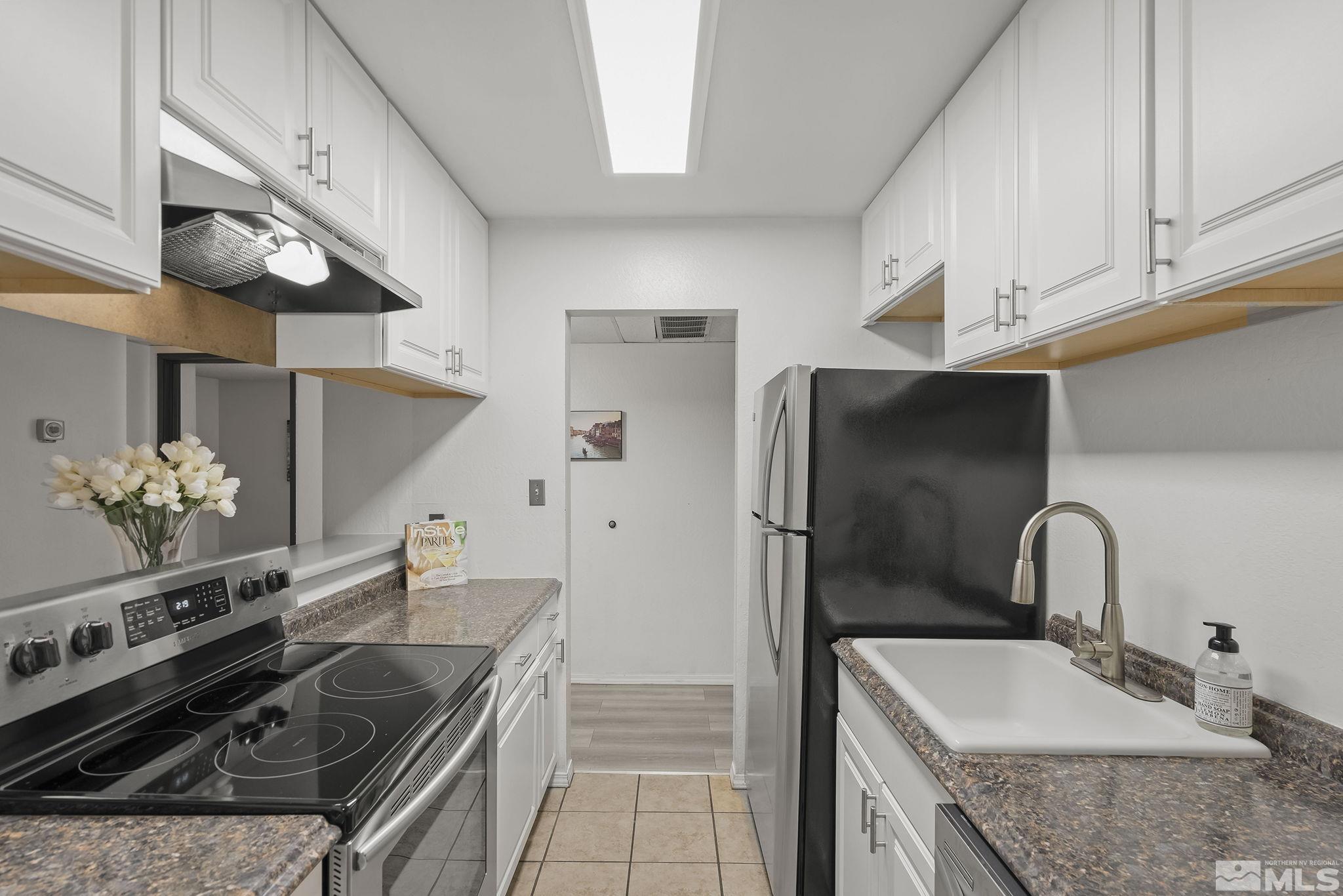 1000 Beck Drive, Unit 170 Reno, NV 89509 - Photo 12 of 23 a kitchen with stainless steel appliances granite countertop a sink stove and refrigerator