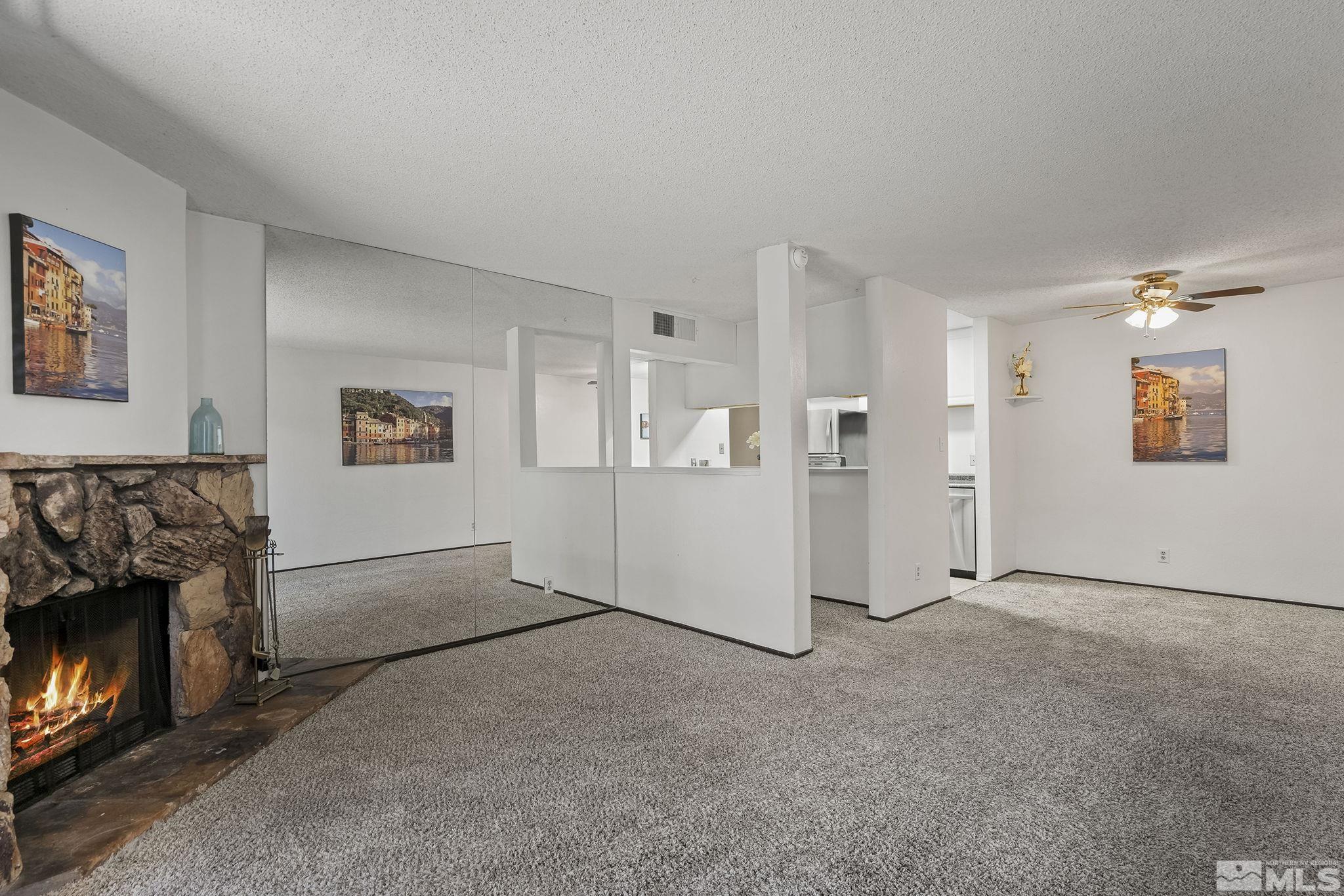 1000 Beck Drive, Unit 170 Reno, NV 89509 - Photo 7 of 23 a view of a livingroom with an empty space and a fireplace