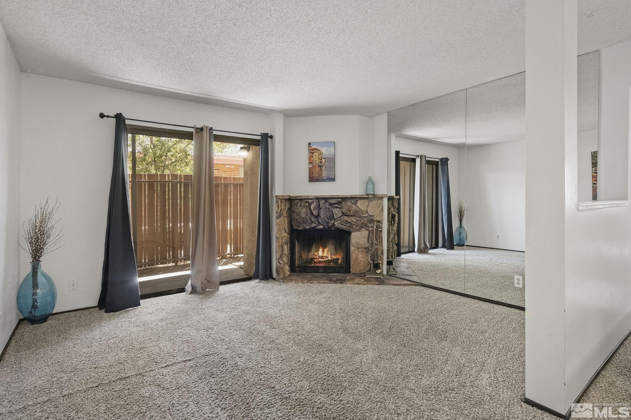 1000 Beck Drive, Unit 170 Reno, NV 89509 - Photo 9 of 23 a living room with furniture and a fireplace