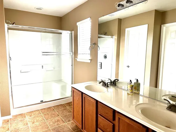 a bathroom with a double vanity sink and a mirror
