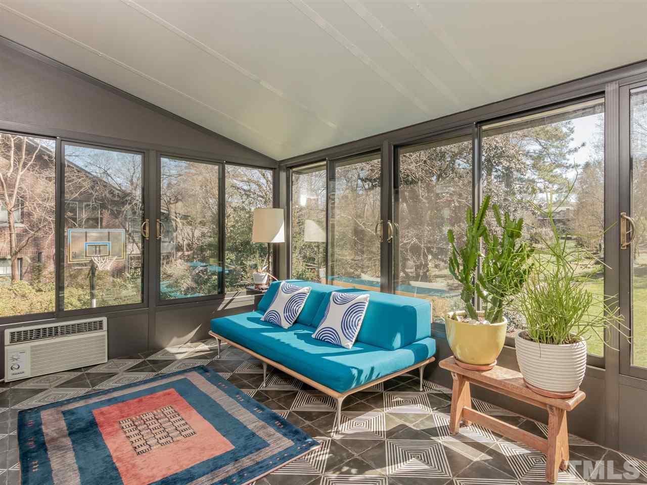 1902 Alexander Road Raleigh, NC 27608 - Photo 16 of 30 a living room with furniture and a floor to ceiling window