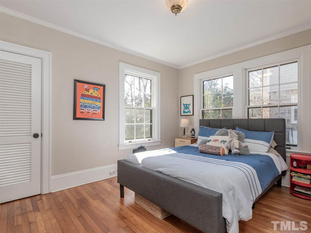 1902 Alexander Road Raleigh, NC 27608 - Photo 19 of 30 a bedroom with a bed and wooden floor