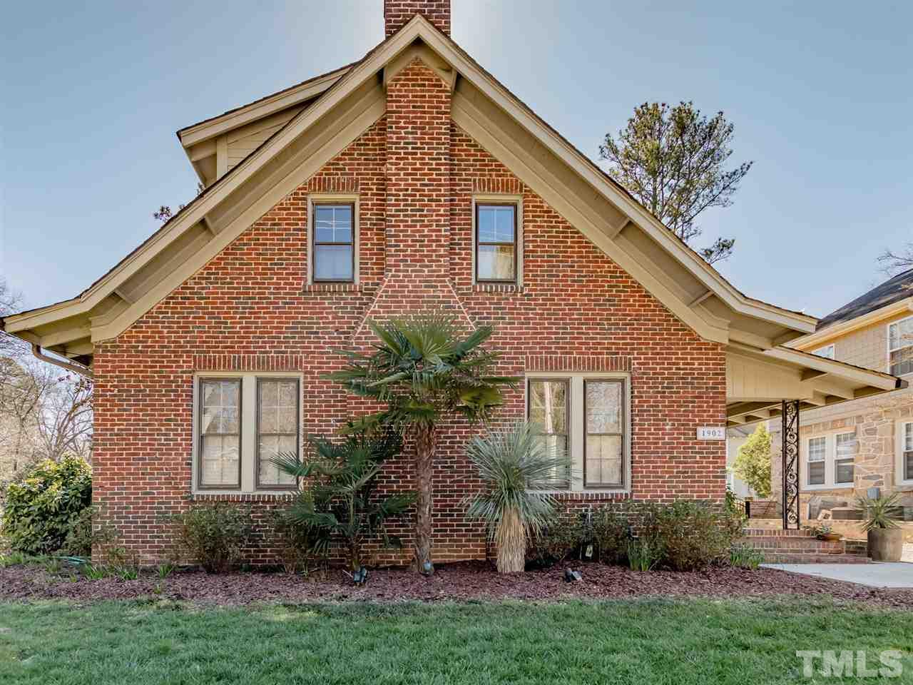 1902 Alexander Road Raleigh, NC 27608 - Photo 3 of 30 a front view of a house with a garden and plants