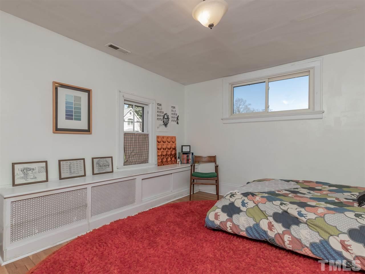 1902 Alexander Road Raleigh, NC 27608 - Photo 24 of 30 a bedroom with a bed and a workspace