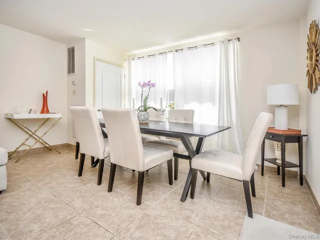 a view of a dining room with furniture and a window