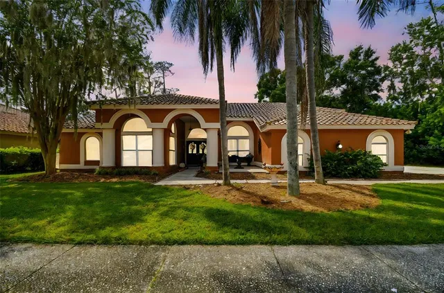 a front view of a house with garden and porch