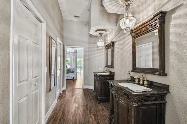 a living room with furniture a fireplace and a chandelier