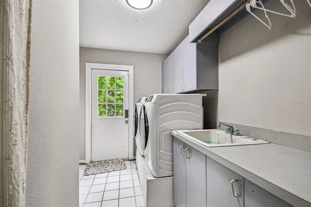 a kitchen with stainless steel appliances granite countertop a stove top oven a sink dishwasher a dining table and chairs with wooden floor