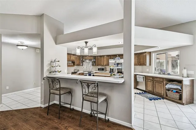 a view of a patio with table and chairs and floor to ceiling window