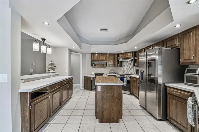 an aerial view of a house with plants and large trees