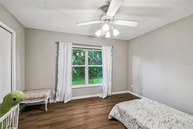 an aerial view of residential houses with outdoor space and trees all around