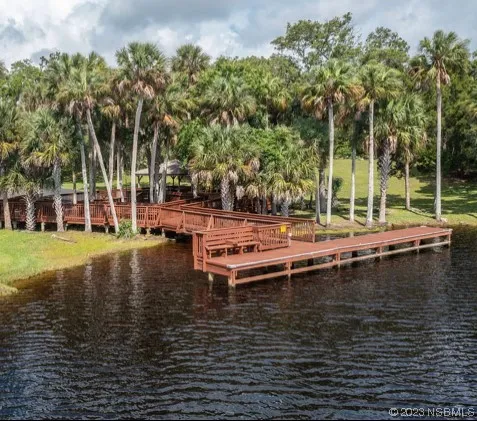 a view of a lake with chairs