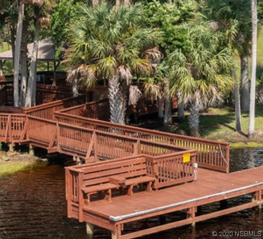 1003-1005 Highway 1 Ormond Beach, FL 32174 - Photo 12 of 52 a view of a roof deck with wooden floor and fence next to a yard