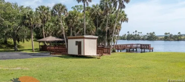 a view of a house with swimming pool and sitting area