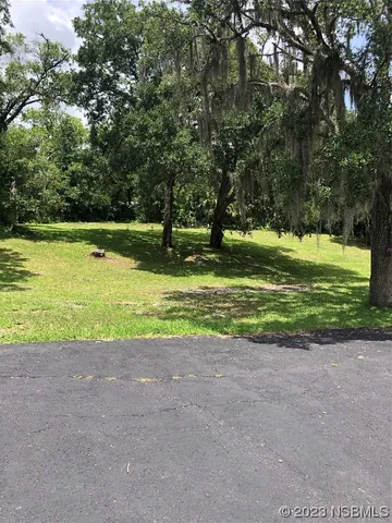 a view of a golf course with trees