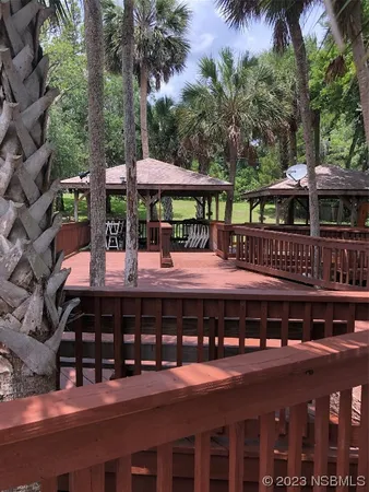 a view of a swimming pool with deck and plants