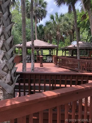 a view of a swimming pool with deck and plants