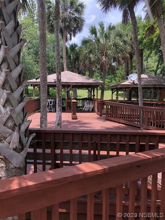 1003-1005 Highway 1 Ormond Beach, FL 32174 - Photo 20 of 52 a view of a swimming pool with deck and plants