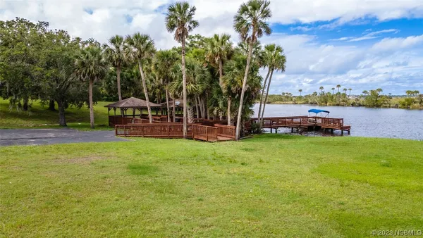 a view of backyard with swimming pool and furniture