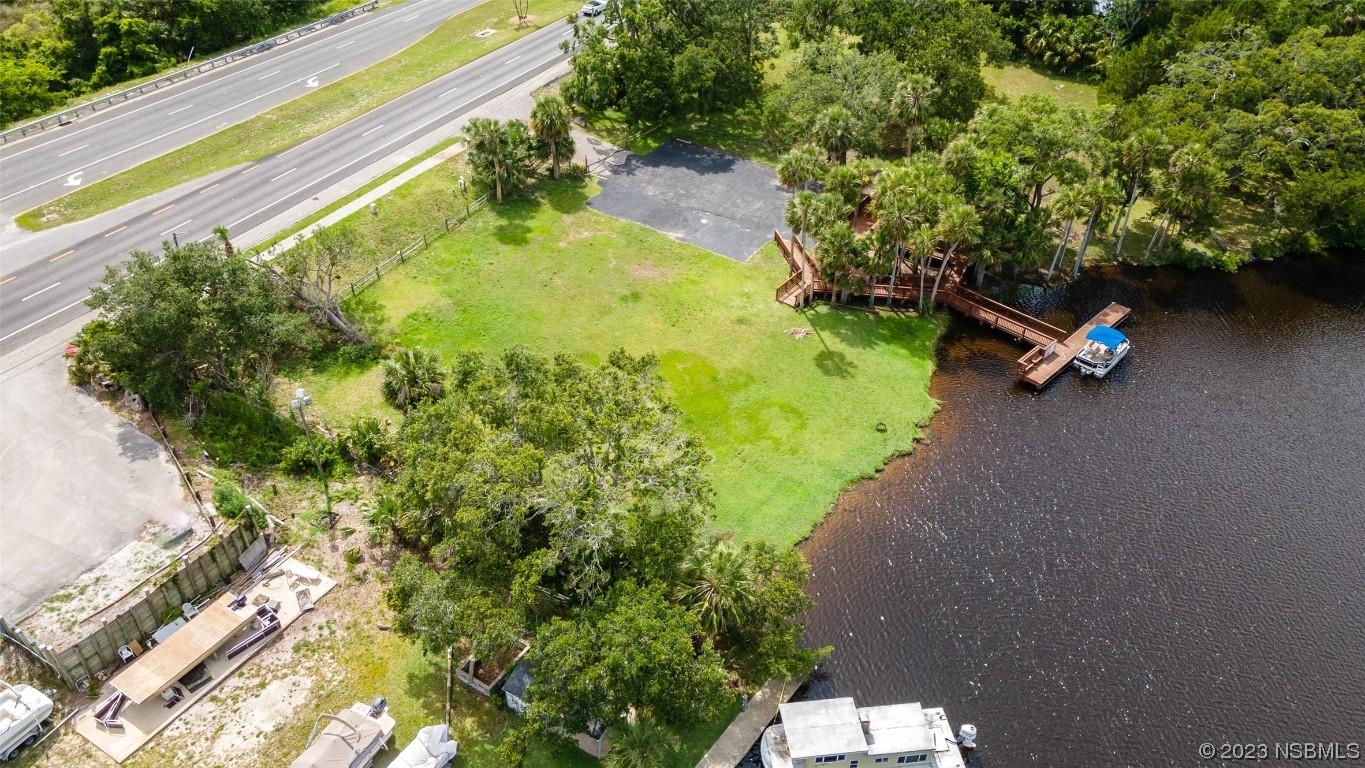 1003-1005 Highway 1 Ormond Beach, FL 32174 - Photo 45 of 52 a backyard of a house with a yard and outdoor seating