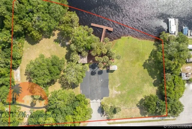 an aerial view of a residential houses with outdoor space