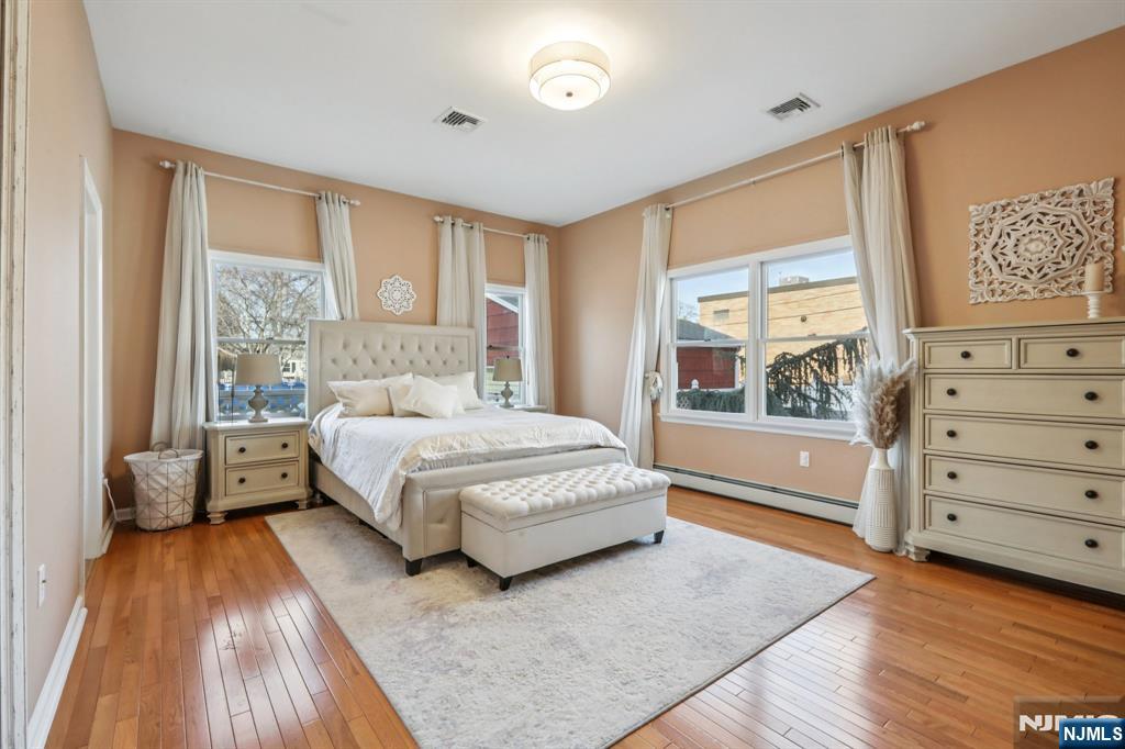 28 George Street Saddle Brook, NJ 07663 - Photo 14 of 50 a spacious bedroom with a large bed and a window