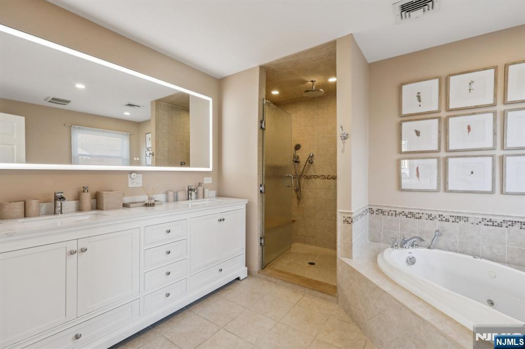 28 George Street Saddle Brook, NJ 07663 - Photo 18 of 50 a bathroom with a tub sink double vanity and windows