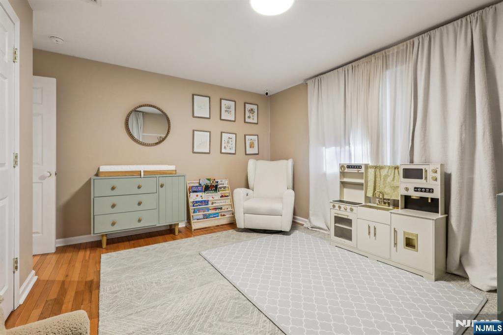 28 George Street Saddle Brook, NJ 07663 - Photo 20 of 50 a living room with furniture and a flat screen tv