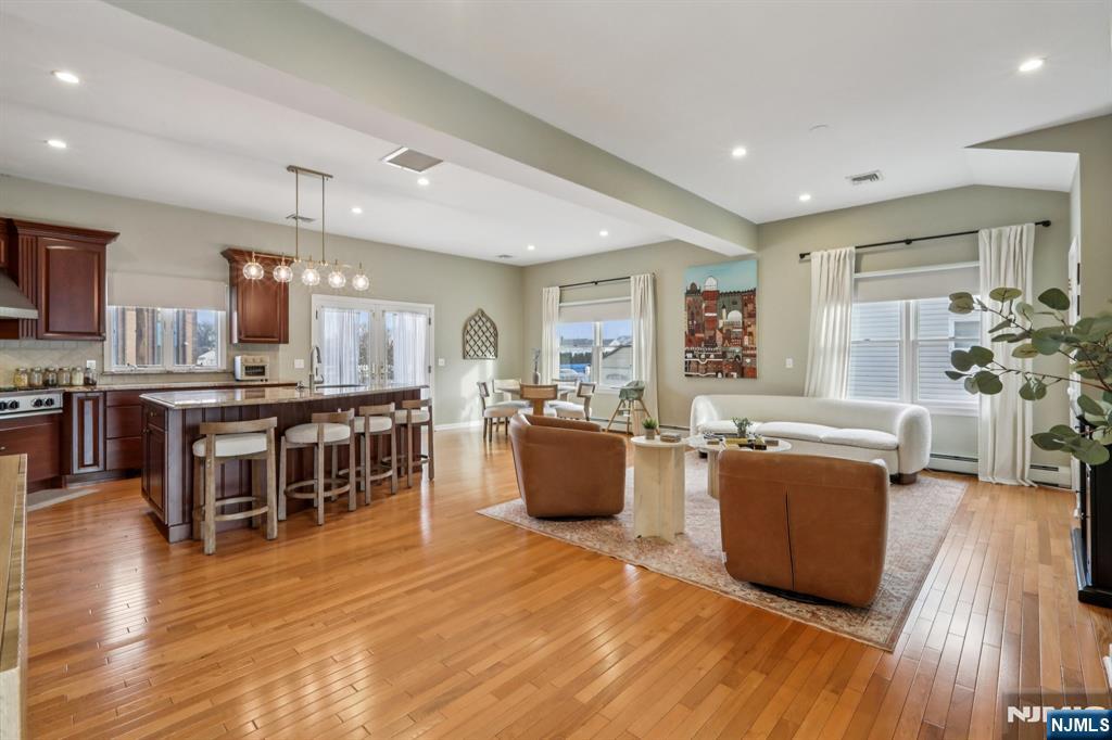 28 George Street Saddle Brook, NJ 07663 - Photo 2 of 50 a living room with furniture and kitchen view