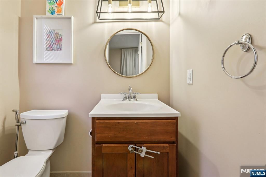28 George Street Saddle Brook, NJ 07663 - Photo 21 of 50 a bathroom with a sink mirror and toilet