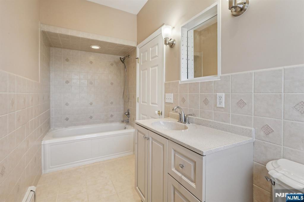 28 George Street Saddle Brook, NJ 07663 - Photo 32 of 50 a bathroom with a sink a toilet and shower