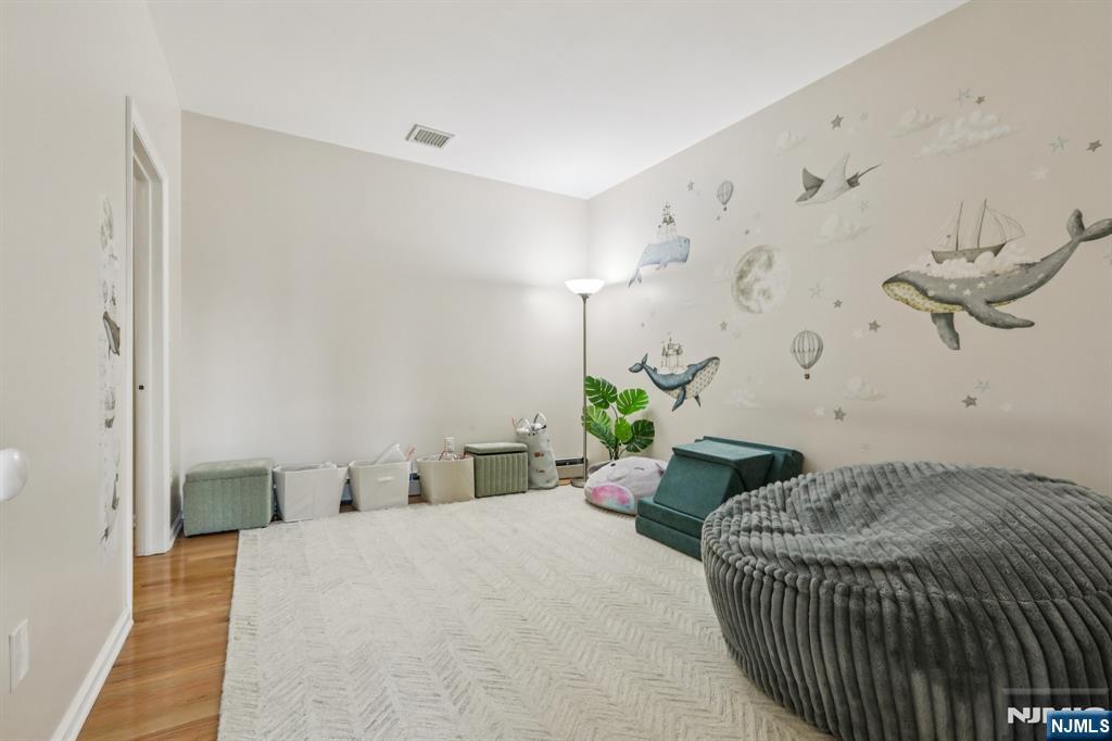 28 George Street Saddle Brook, NJ 07663 - Photo 33 of 50 a bedroom with a bed and ceiling fan